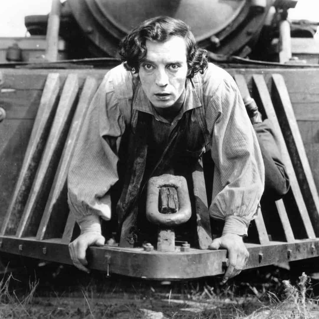 Buster Keaton performing a stunt on a train in The General